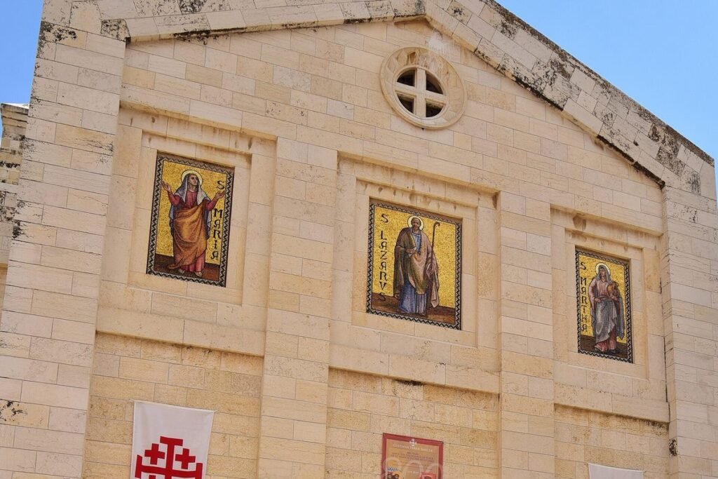 Facade of the Church of St. Lazarus with a round window and three images of saints